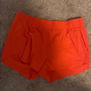 orange athleta running shorts